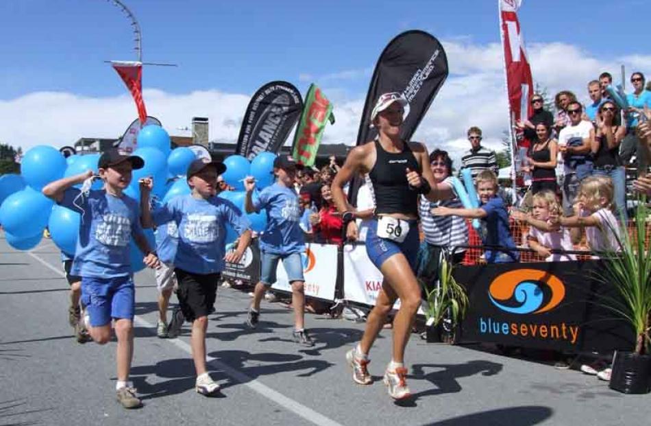 Women's winner Gina Ferguson crosses the finish line.