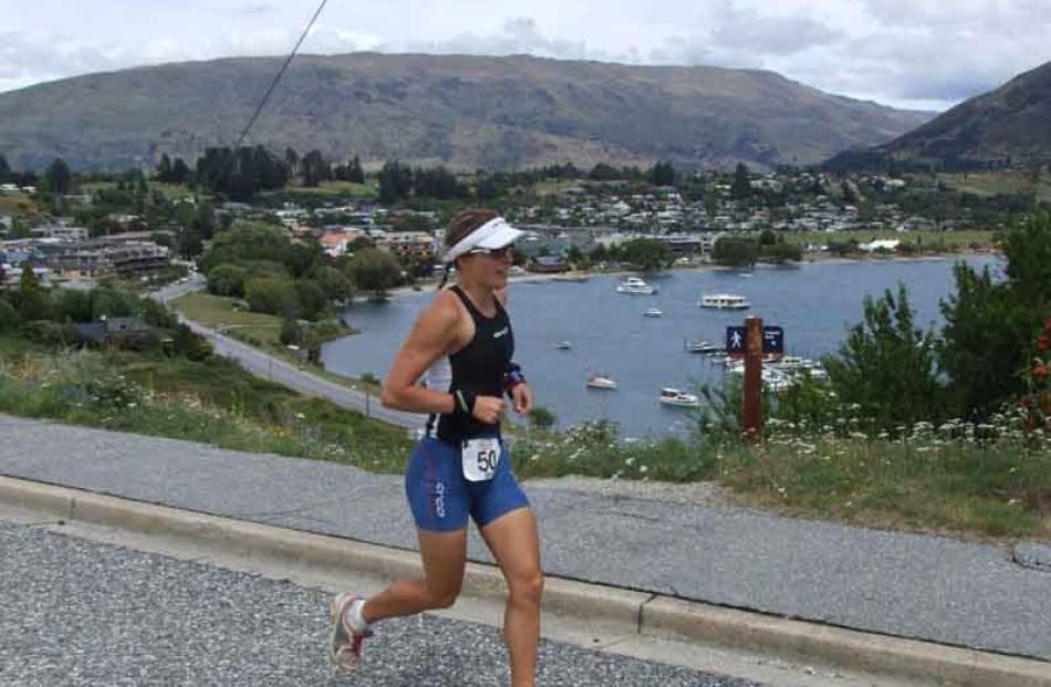 Gina Ferguson runs above Wanaka township on her way to complete her first lap during the 42km...