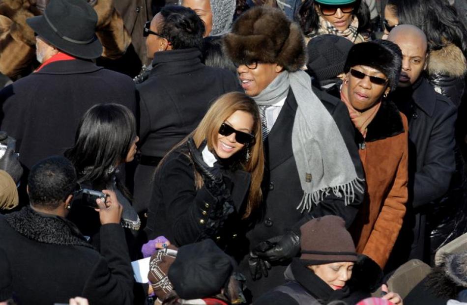 Jay-Z and Beyonce try to find their seats as they arrive for the inauguration ceremony at the US...