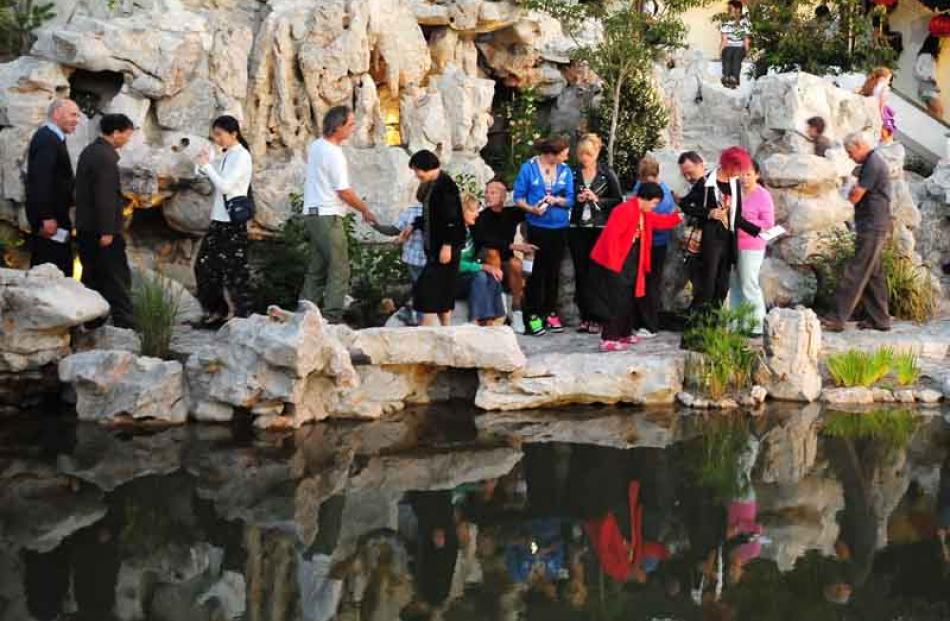 Revellers scramble over the natural rocks of the Chinese Garden. Photo by Craig Baxter.