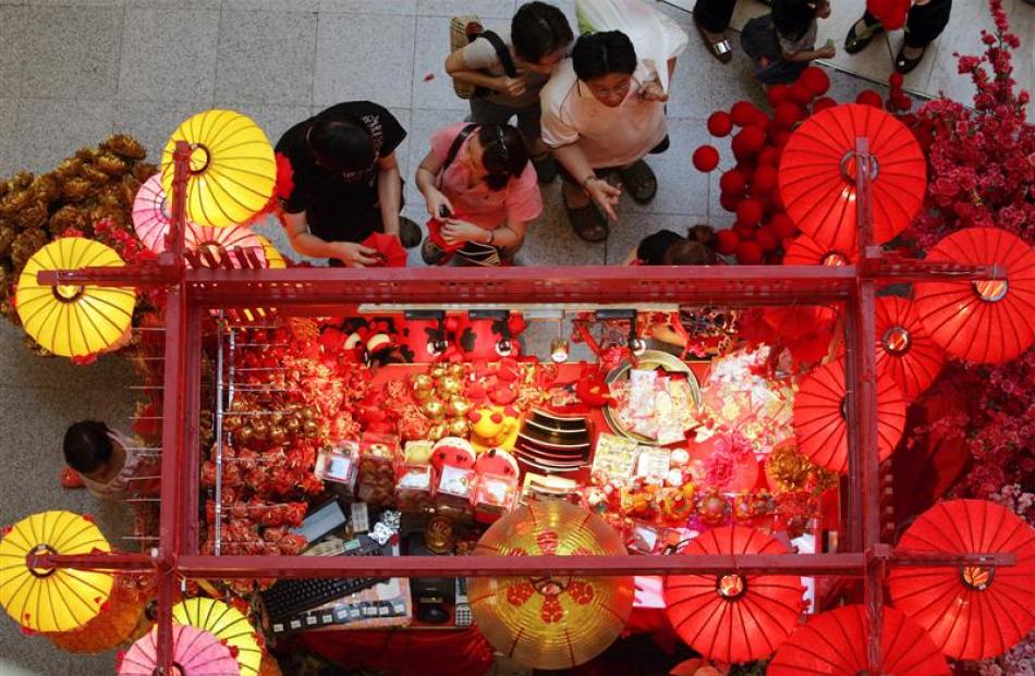 Shoppers look for Chinese New Year decorations at a shopping mall in Kuala Lumpur, Malaysia. ...