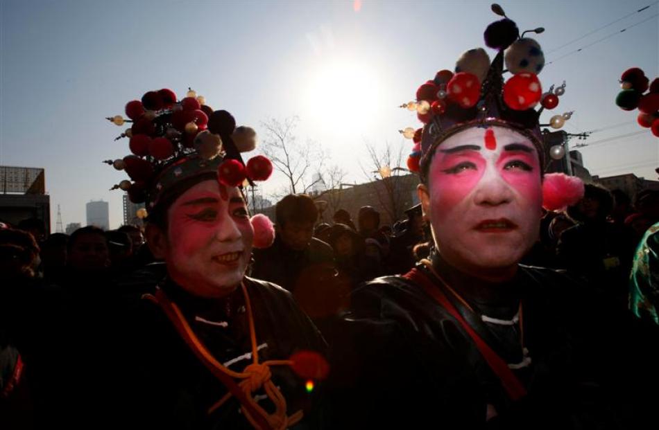 Chinese performers prepare to take part in the entertainment at a temple fair on Chinese New Year...