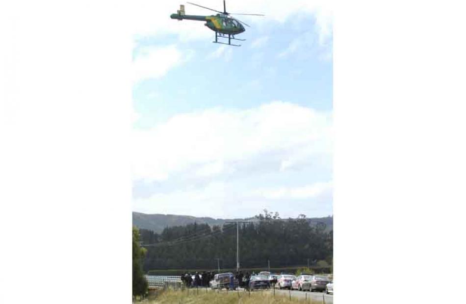 AOS and Police gather on Horse Range Road Bridge by the Shag River after a man was on the loose...