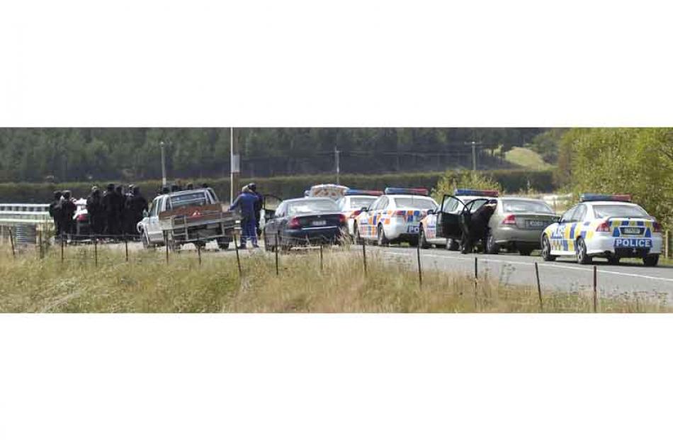 AOS and Police gather on Horse Range Road Bridge by the Shag River after a man was on the loose...