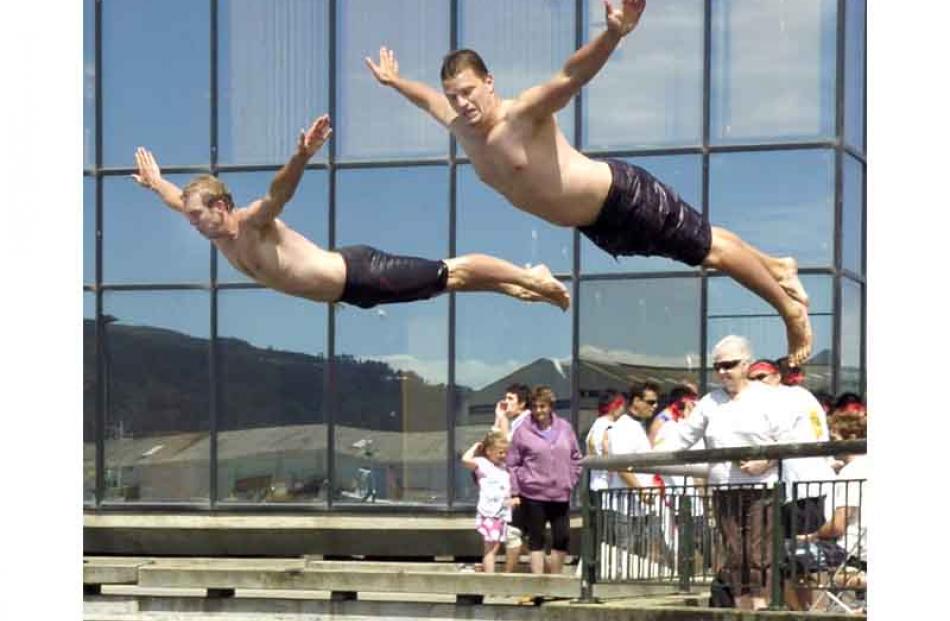 Winning Dunedin City Council team members Mike Kendrick and Eric Deleeuw dive off the wharf.