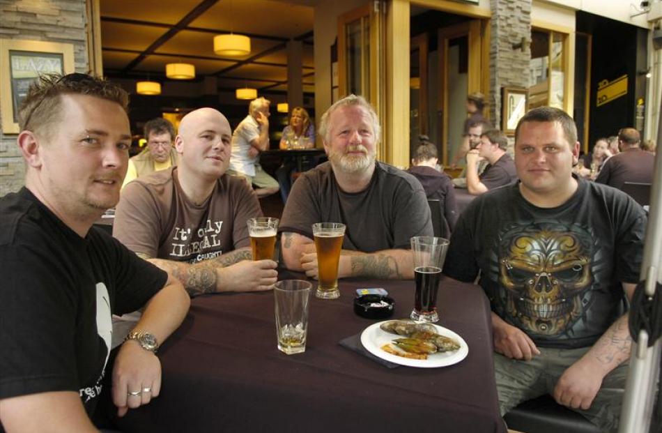 Enjoying a beer in the Octagon yesterday, despite the 15% surcharge, are (from left), Stuart...