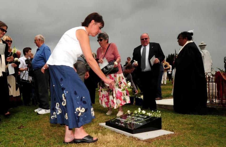 Paula Wells, a descendent of Minnie Dean, lays flowers on the grave.