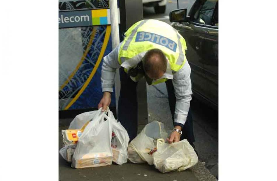 A police officer collects egg crates.