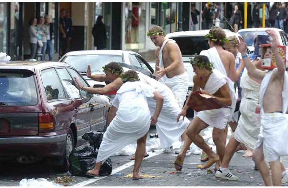 Toga wearers remonstrate with occupants of a car in George Street.