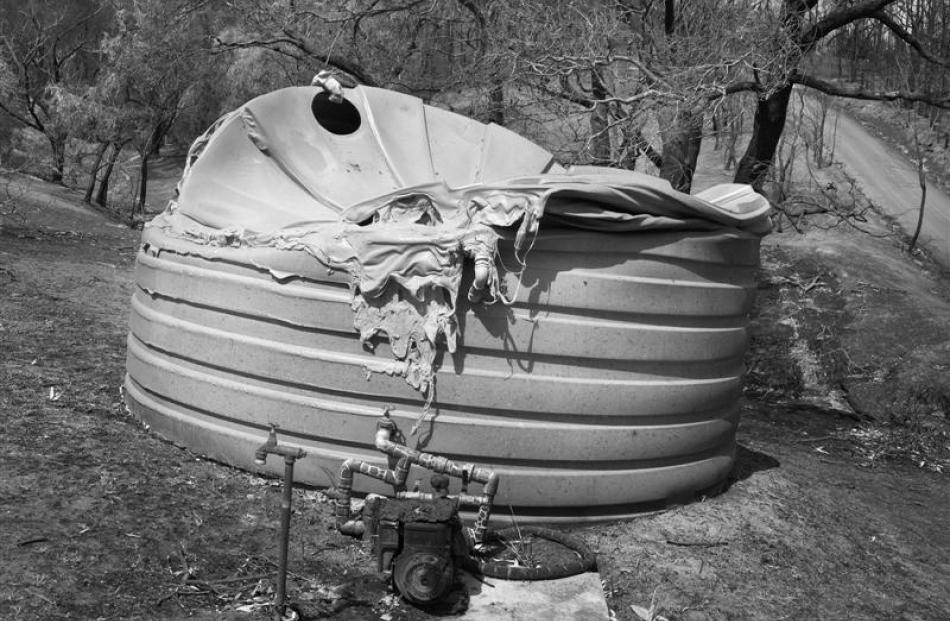 A water tank melted by heat from the fires near Steels Creek. Photo by Alan Dove.