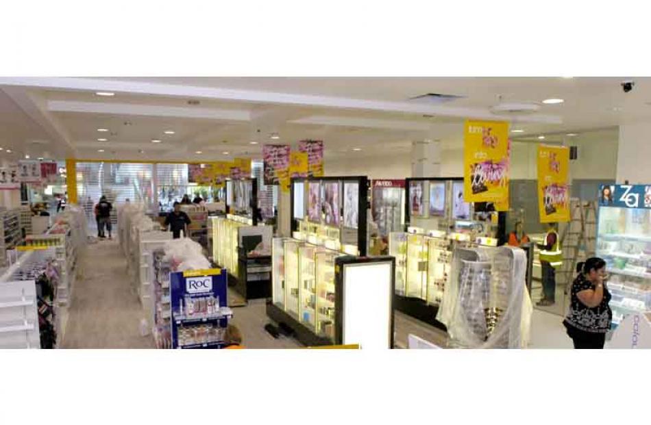 Retail workers stock one of the new shops. Photo by Jane Dawber.