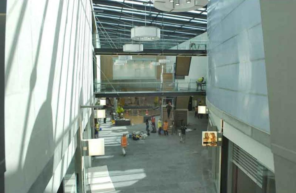 The heat-absorbing stone wall (left) is used to moderate the temperature inside the mall. The...