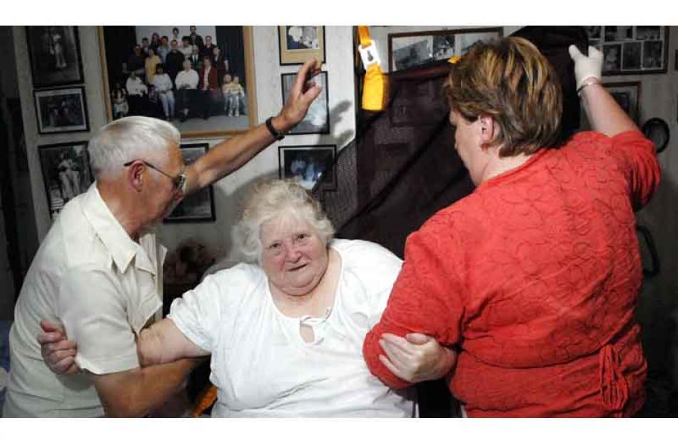 7:40pm: Enliven Home Support Worker Erin O'Donnell (right) helps Edna Hughes (78) of Mosgiel get...