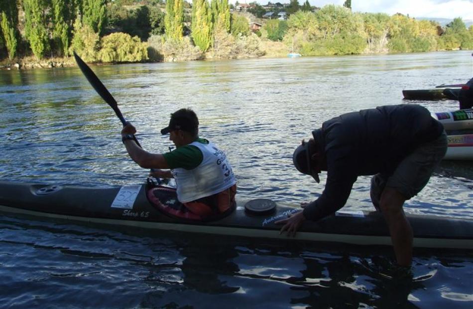 Nelson's Tony Baldwin gives his team open men's kayaker Bob McLachlan, of Wanaka, a heave into...