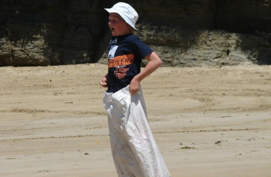 Brady Clement (11), of Balclutha, competes in the sack race at Tautuku Peninsula New Year’s eve...