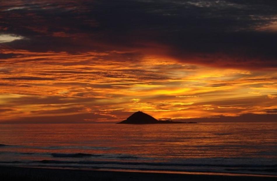 Sunrise over Green Island, taken from Brighton Beach. Photo by David Robson.