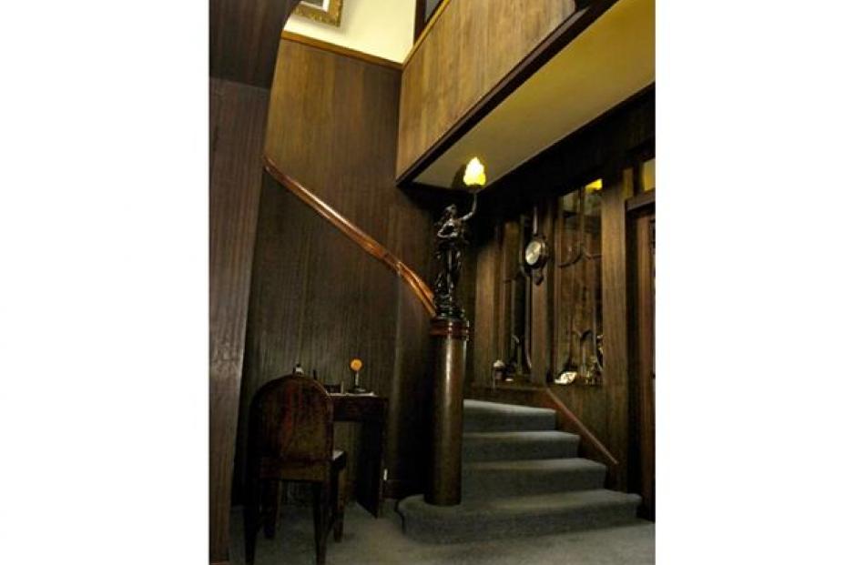 The central stairwell in the Hudson house with undecorated paneling curving round the stairs.