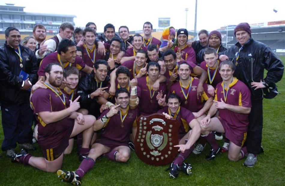Alhambra-Union players and management pose with the trophy after beating Dunedin at Carisbrook in...