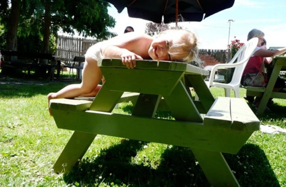 Libby Gordon (2) rests after lunch at the Bannockburn Hotel Garden playground. Photo by Joy...