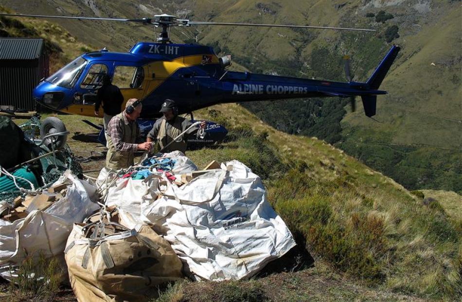 Packing up their kit for an airlift after restoring McIntyres hut in February are Doc Wakatipu...