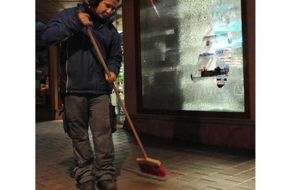 Queenstown Lakes District Council worker Joel Marquas, of Queenstown, sweep a town centre street...