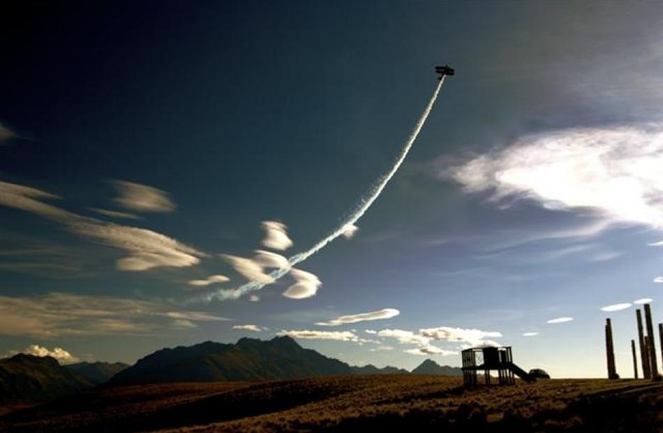 A Red Bull plane above Queenstown Hill. Photo by Allan Johnston.