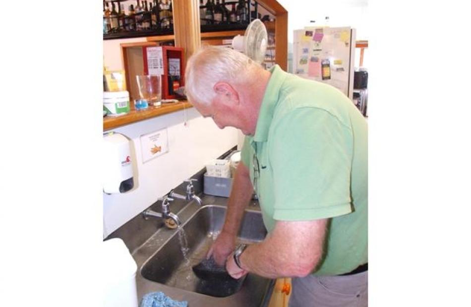 Kingston's Peter McEntyre washes dishes on Friday night. Photo by