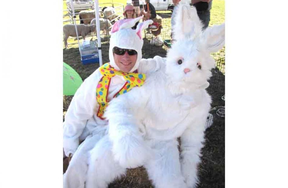 Two Easter bunnies delighted children with chocolate treats.