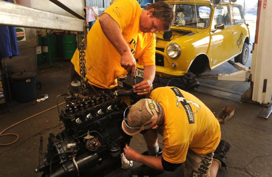 West Aucklanders Brett Ireland (left) and Gavin Field work to replace their broken engine at...