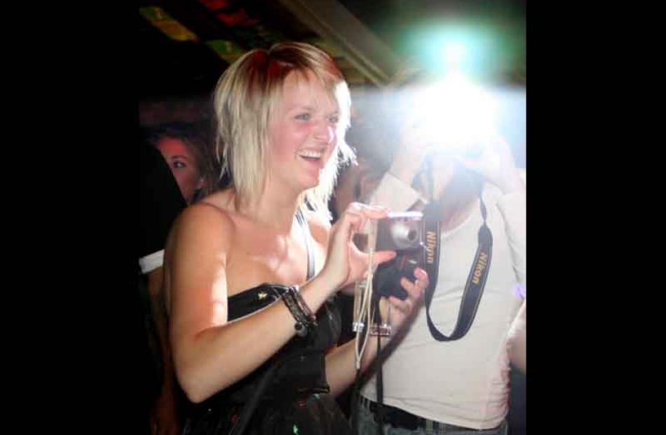 Queenstown clubbies Erin Kutor (left) and Sara Friden (behind the flash) get photos of their...