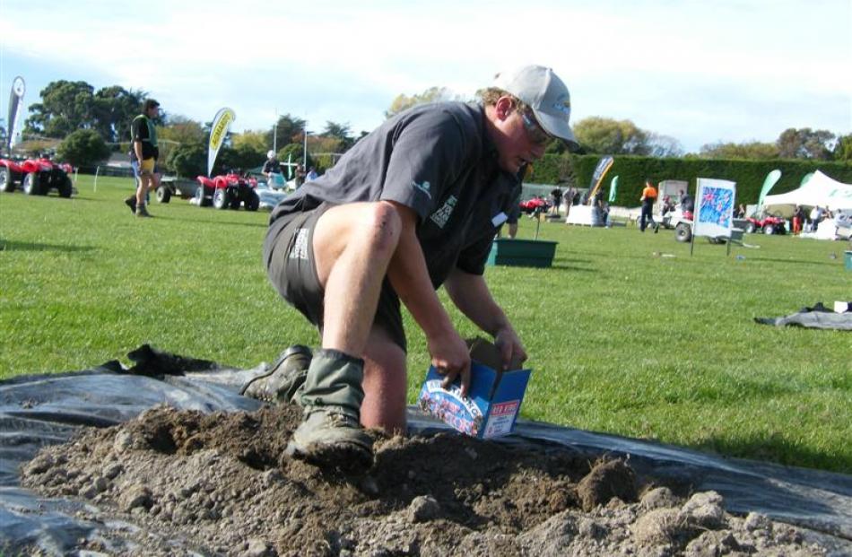 Mackenzie Young Farmers’ Club member Andrew Scott, of Cave, searches for potatoes in a mound of...