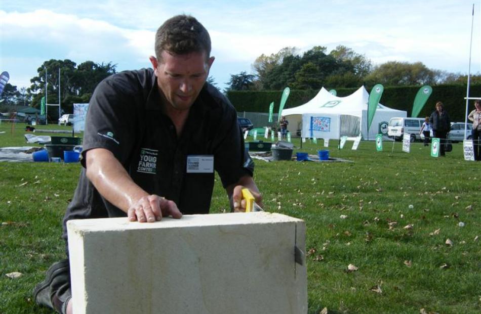 Methven Young Farmers’ Club, Ben Johnson, of Westerfield, saws a block of Oamaru stone to...