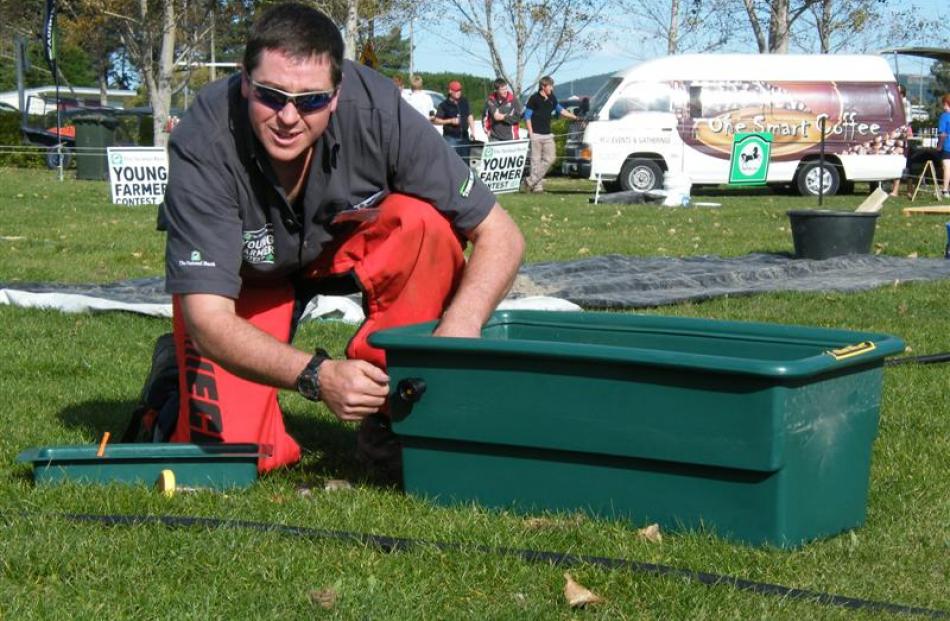 Glenavy Young Farmers’ Club member Dave Affleck, of Oamaru, plumbs a water trough in the...