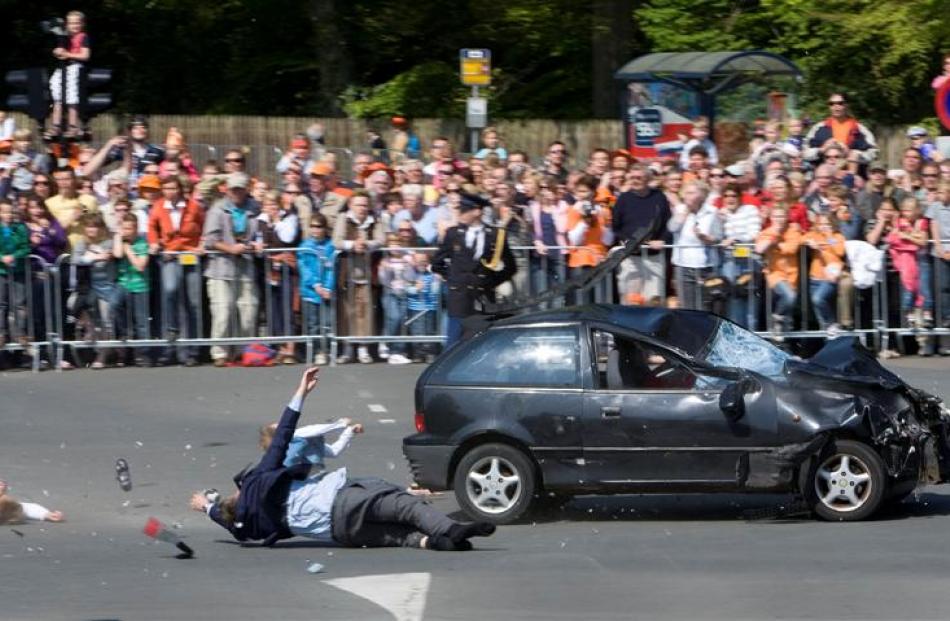 A car ploughs through spectators in Apeldoorn, Netherlands as it races toward an open bus...