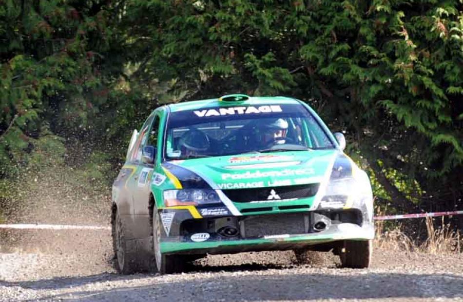 Hayden Paddon corners his Mitisubishi Lancer Evo 9 during the last stage on his way to winning...