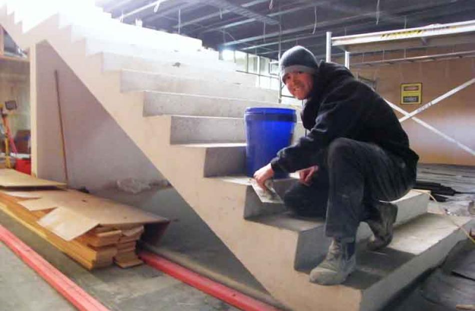 Stone Heritage stonemason Dan Jones works on the staircase in the Quiksilver store.