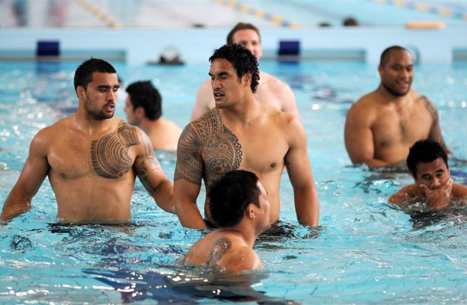 All Blacks Liam Messam (left) and Jerome Kaino (centre) warm down at  Moana Pool following a team...