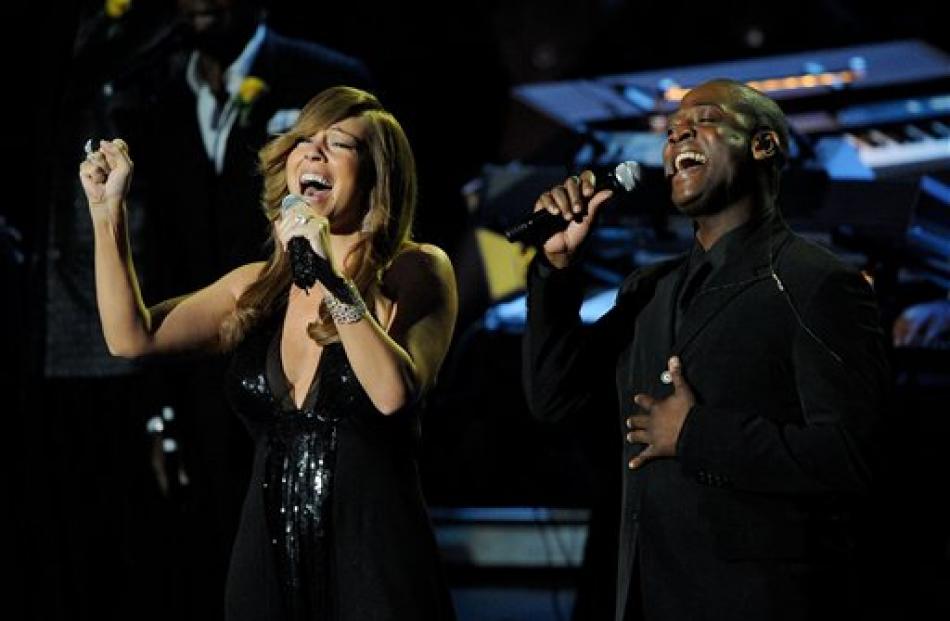 Singers Mariah Carey, left, and Trey Lorenz perform.
