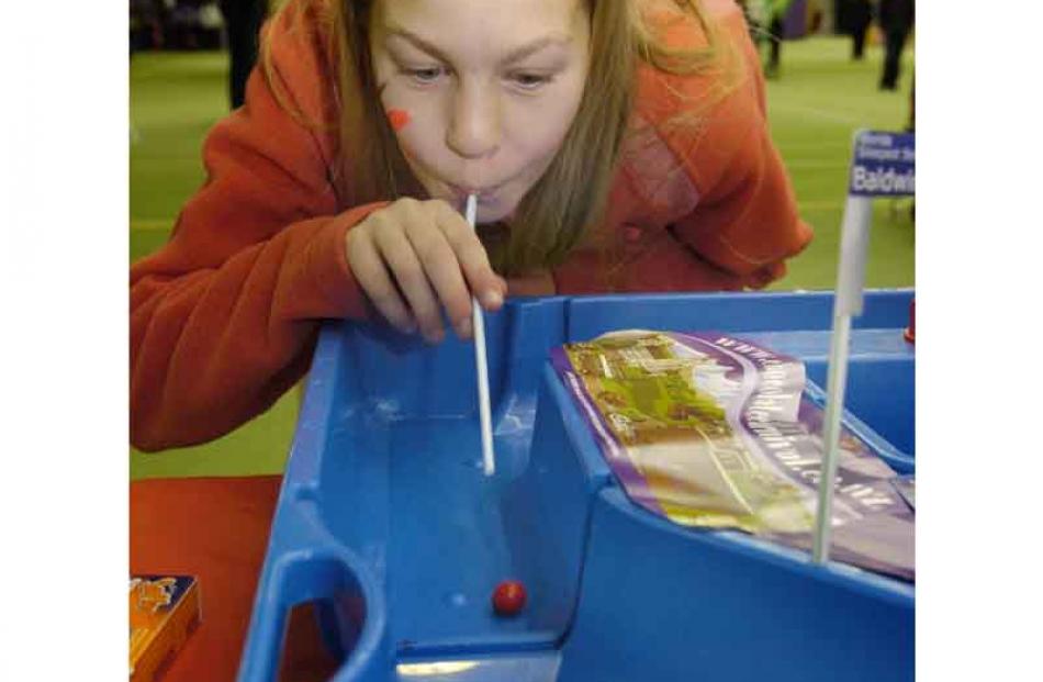Zoe Richards (11), of Dunedin, trying to blow a jaffa around an obstacle course.