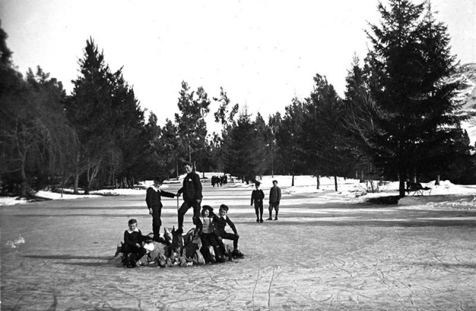 A group of young skaters poses for the camera on the frozen pond at the Queenstown Gardens,...