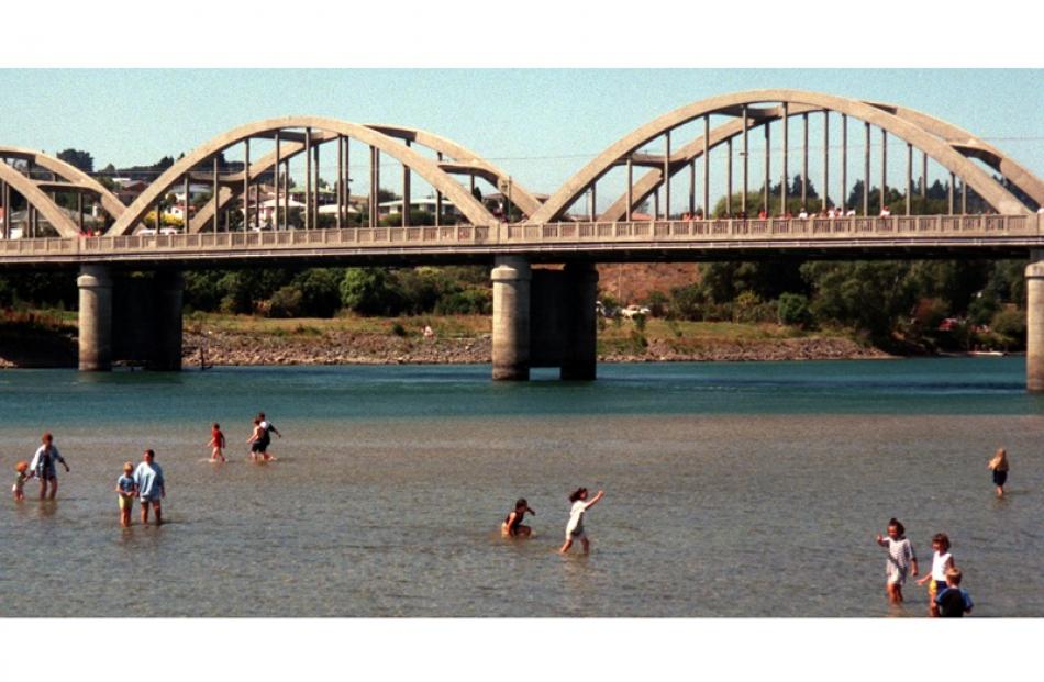 People swim in the Clutha River under the Balclutha bridge in February 1999. Photo by Vivienne...