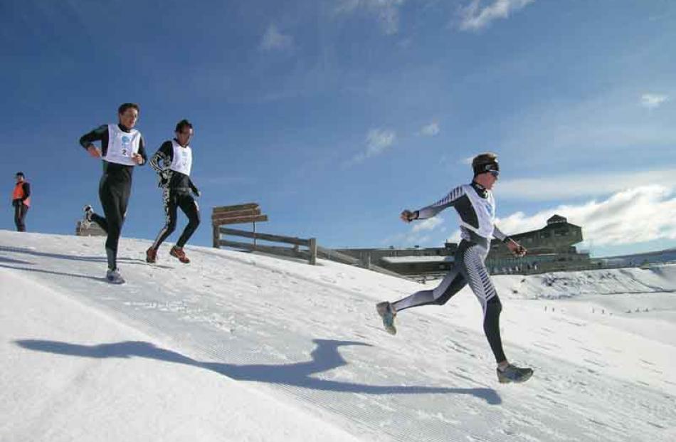 Nat Anglem of NZ (left) and Stephen Waterreus of Canada chase Andy Pohl on the second running lap.