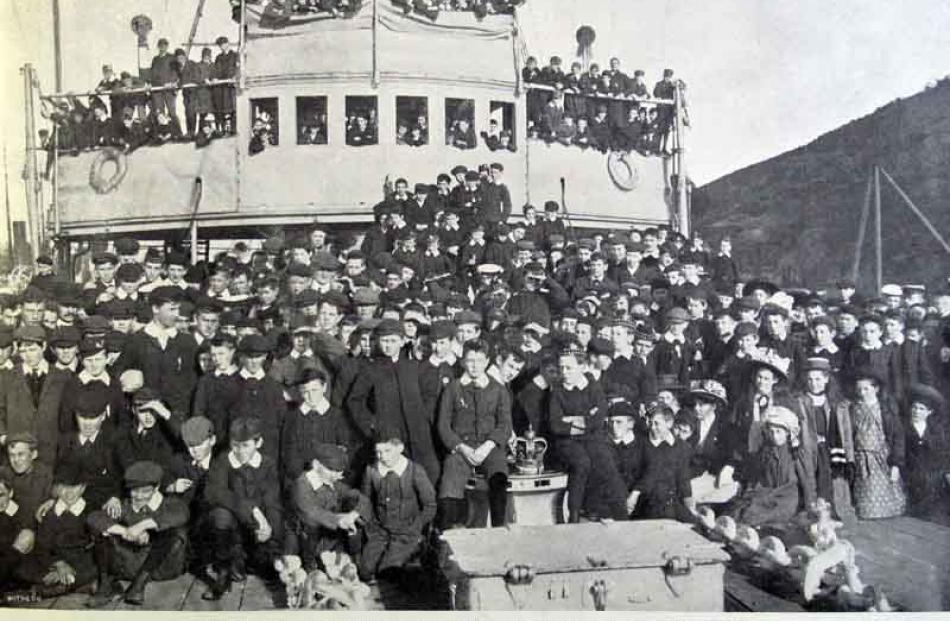 Some of the 600 scholars of Dunedin schools who visited the British second class protected...