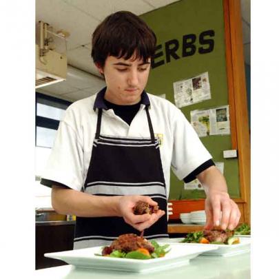 Shay Van der Kraan (16) preps food in the Bayfield High School kitchen.