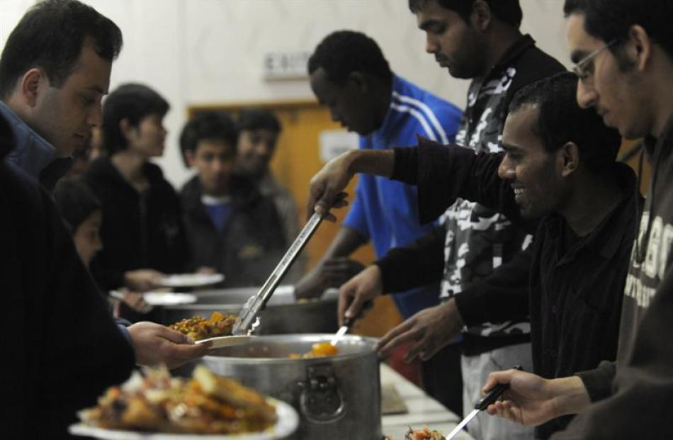 The faithful eat together at the mosque following the prayers. Photo by Peter McIntosh.
