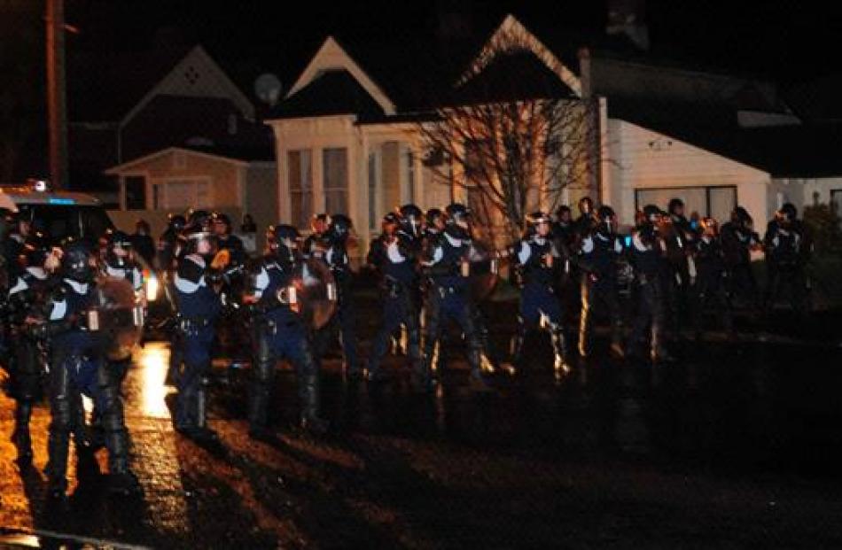 Police in riot gear move in. Photo by Craig Baxter