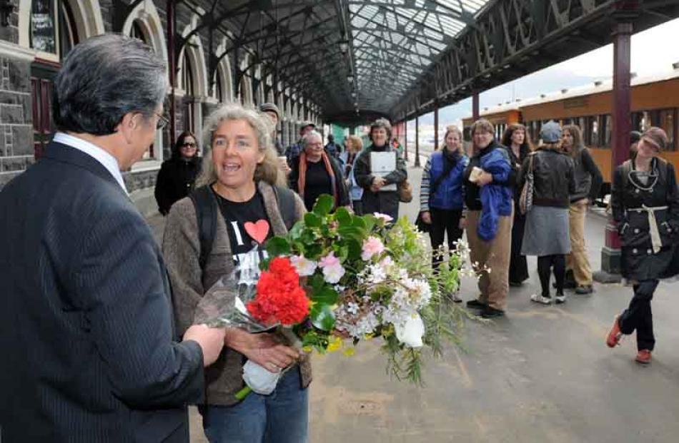 The Mayor accepts a bouquet from Danielle Cameron of Get the Train.