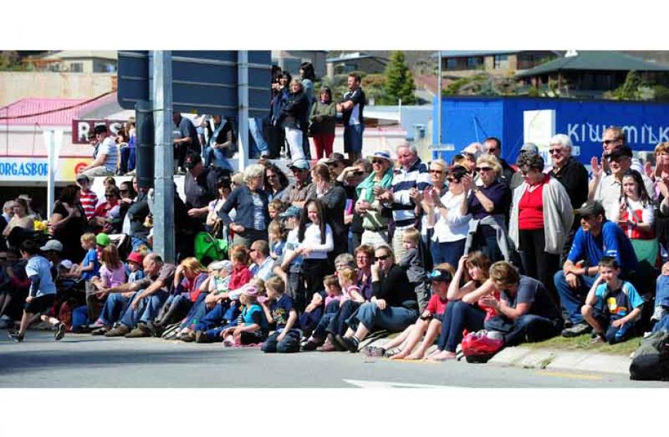 Crowd lines Centennial Ave  during  the Alexandra Blossom Festival Grand Procession on Saturday