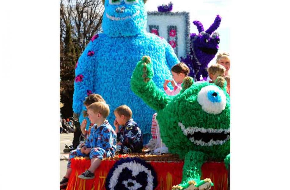 Childen relax beside Sulley and Mike as part of the Monsters Inc.