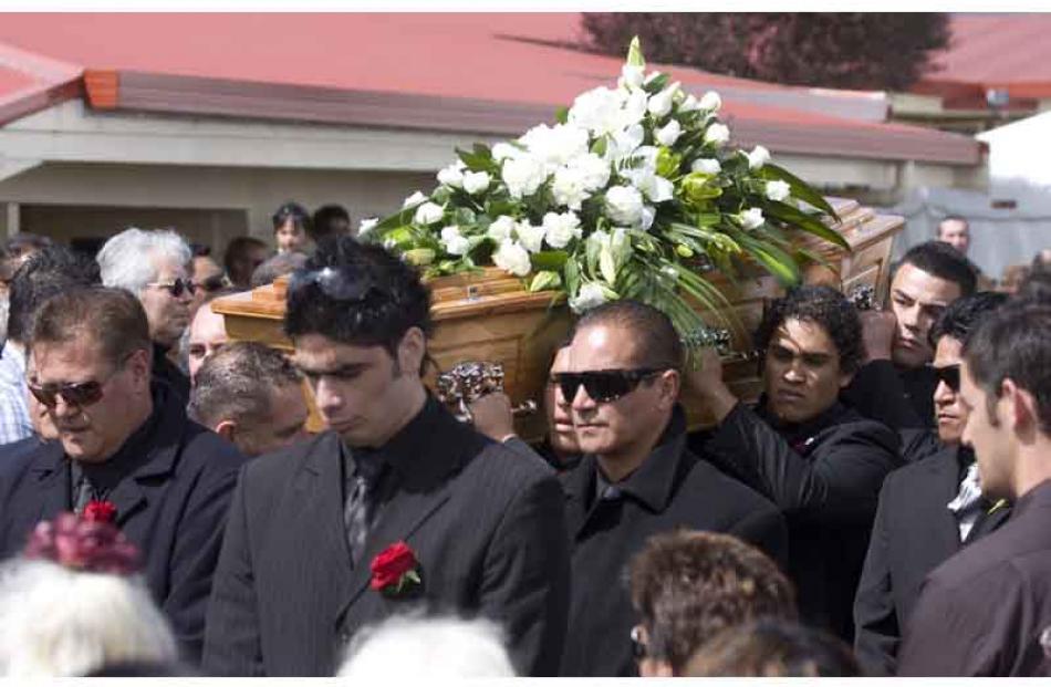 Pallbearers carry Sir Howard Morrison's casket from the marae.